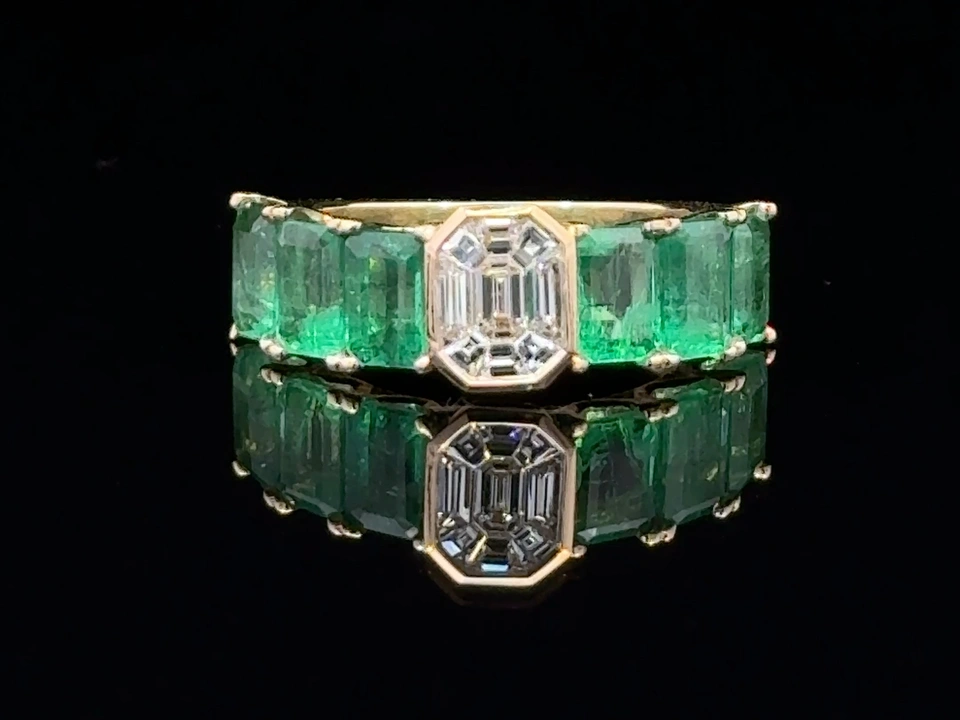 Gold-colored band with green stones and a rectangular clear center stone