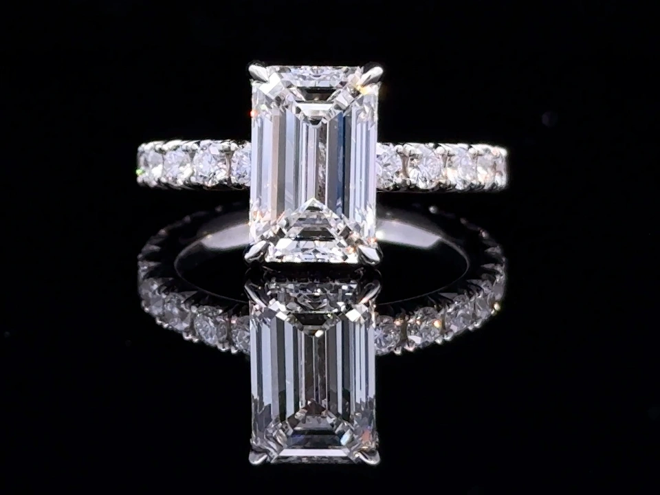 Ring with a rectangular clear center stone and a silver-colored band